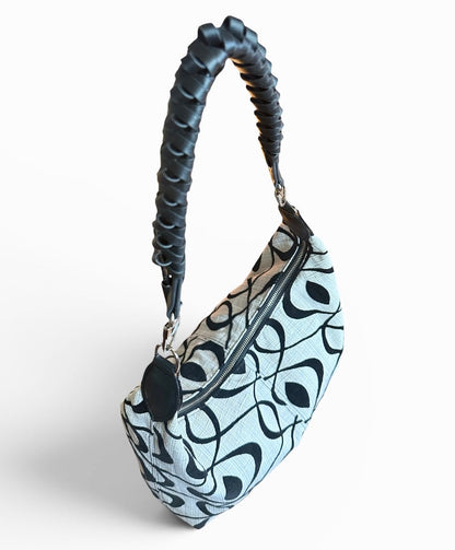Medium black and cream slouchy shoulder bag featuring a handwoven Wayuu strap, spacious interior, and artisan craftsmanship for everyday style.