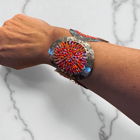 Wrist wearing a colorful beaded bracelet 