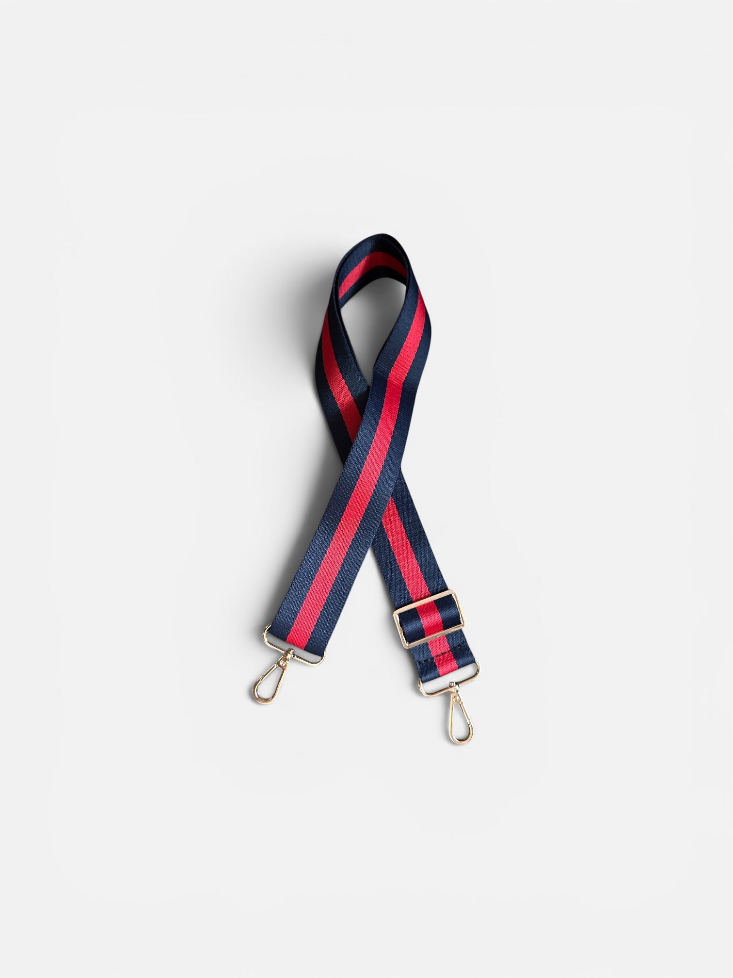 Striped bag strap with red and blue pattern on a white background