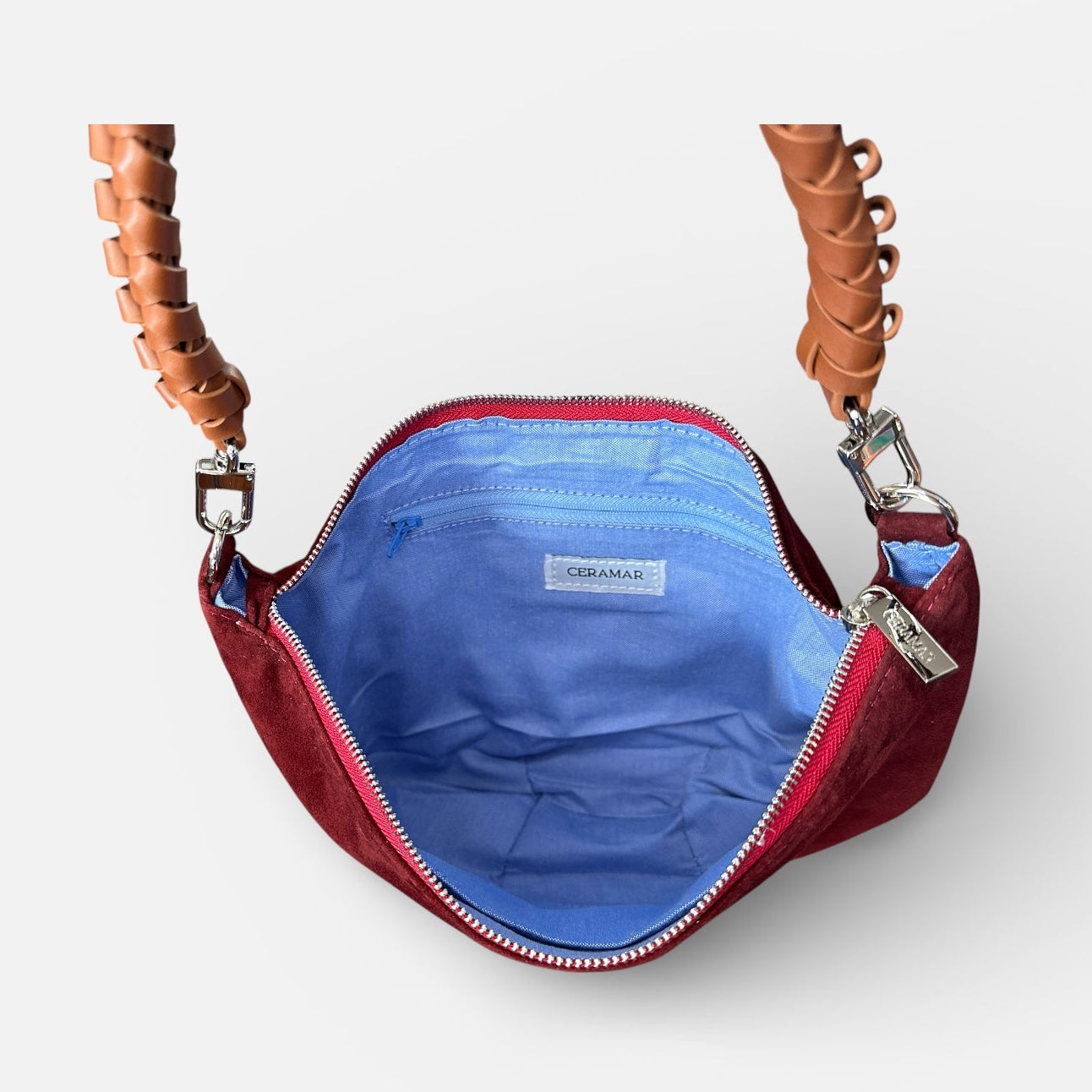 Red handbag with blue interior on a white background