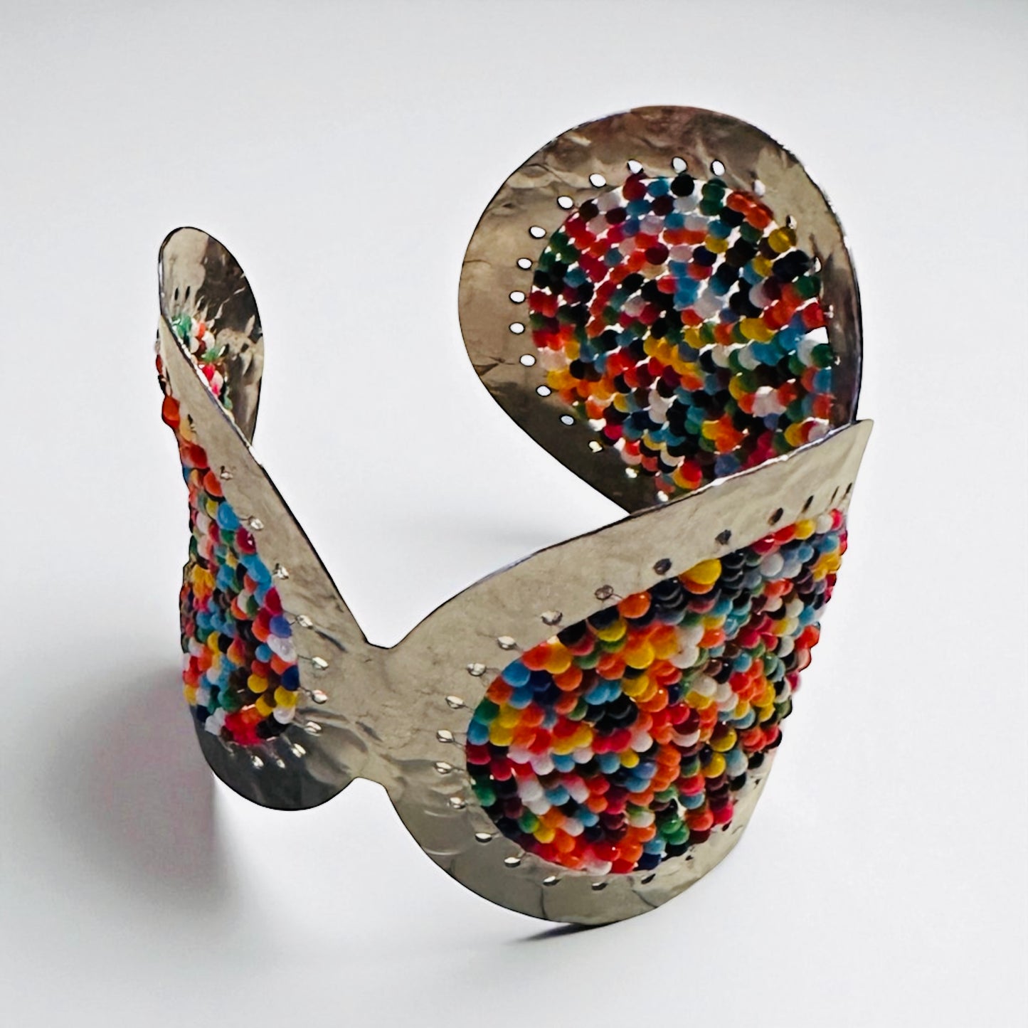 Colorful spiral sculpture with metal and bead design 