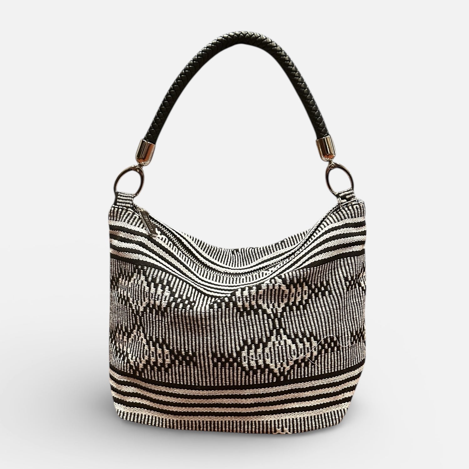 Black and white patterned handbag on a light gray background