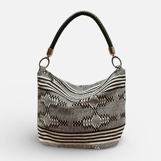 Black and white patterned handbag on a light gray background