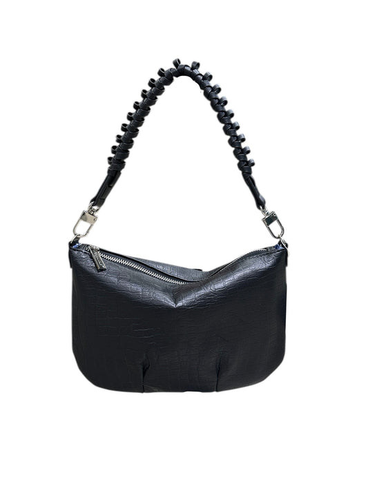 Black handbag with a textured handle on a white background