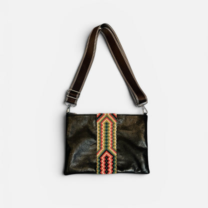 Black leather handbag with colorful strap on a white background
