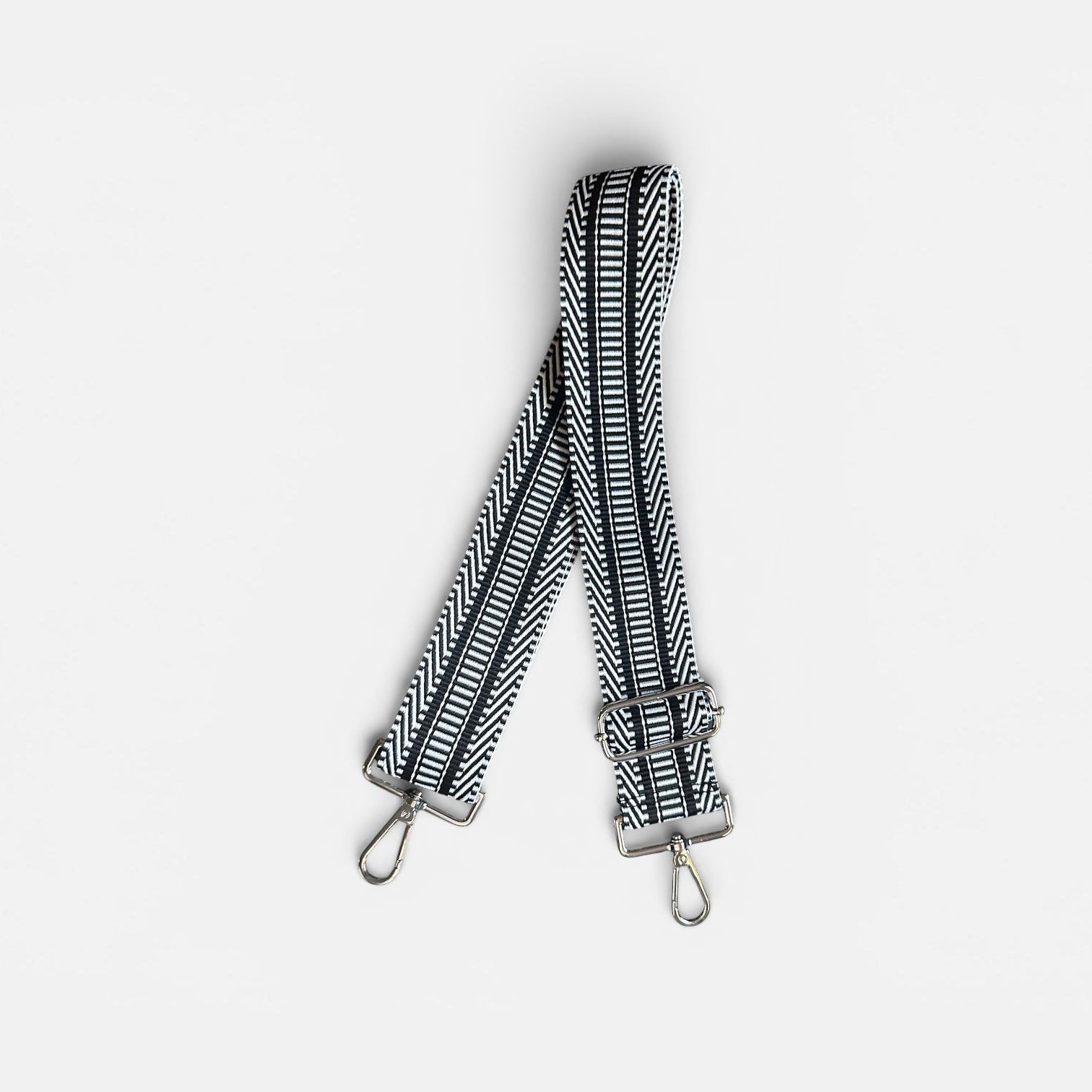 Black and white striped bag strap on a light gray background