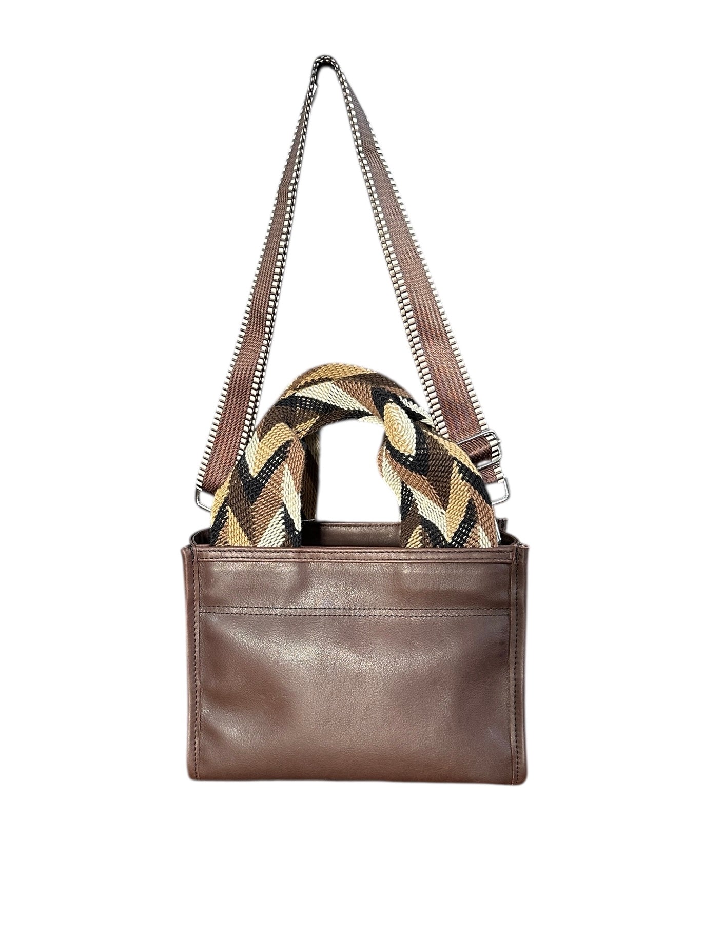 Brown leather handbag with a patterned scarf on a white background