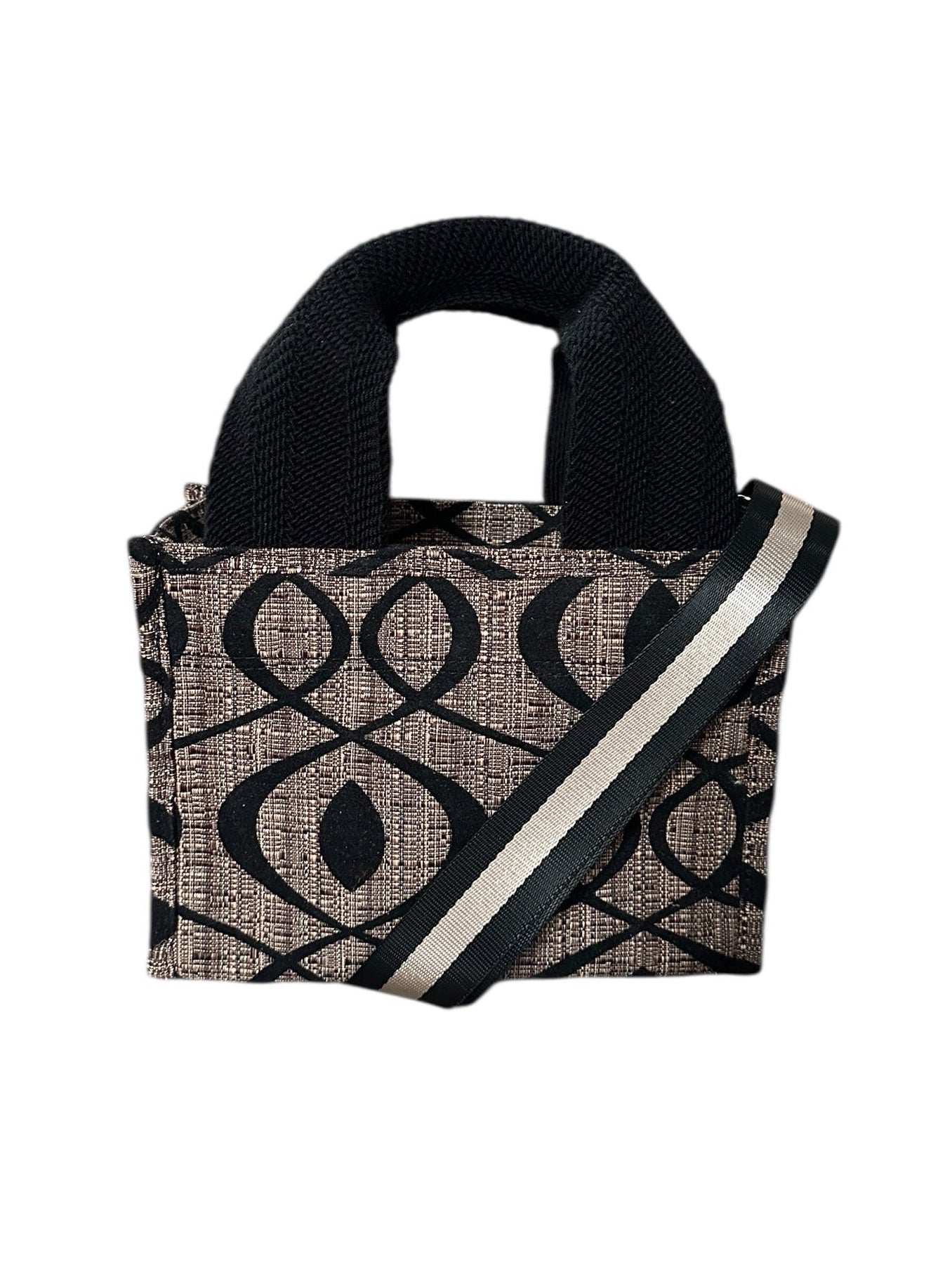 Black and beige patterned handbag with a strap on a white background