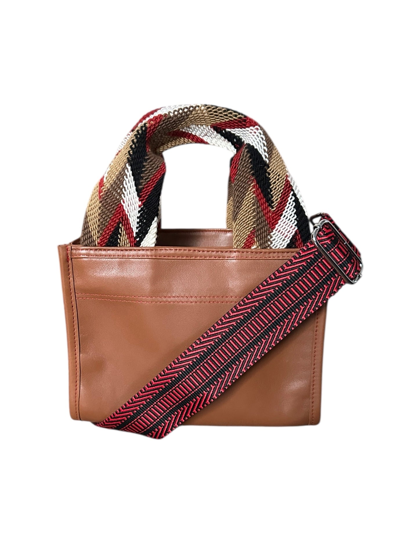 Brown leather handbag with a patterned strap on a white background