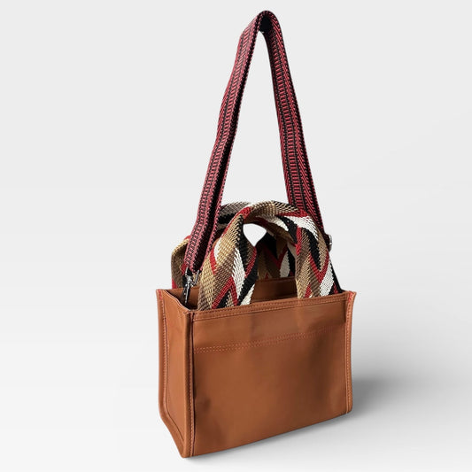 Brown tote bag with plaid patterned interior on a white background