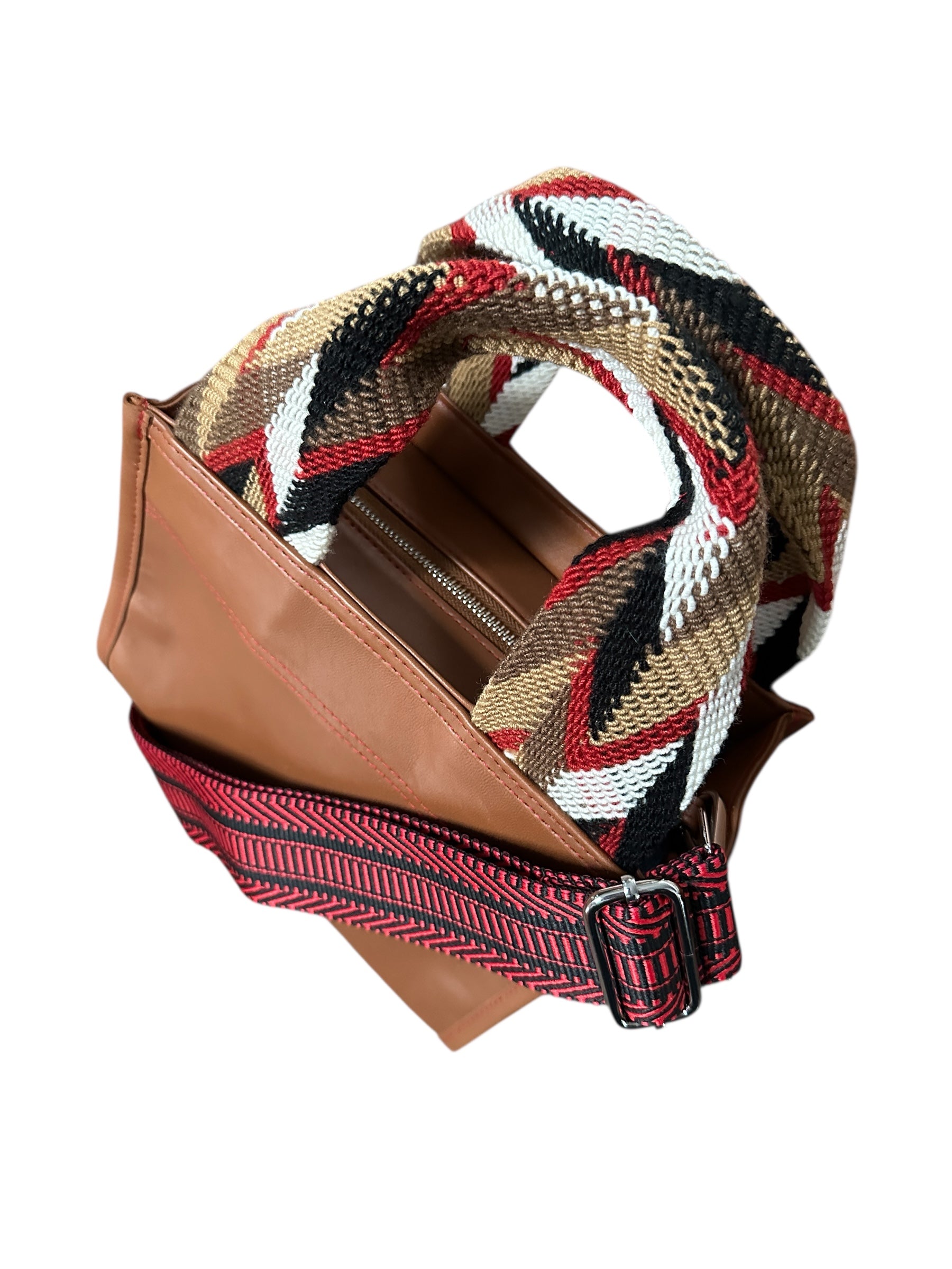 Brown handbag with a colorful woven strap on a white background