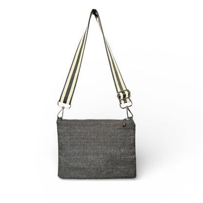 Gray crossbody bag with striped strap on a white background
