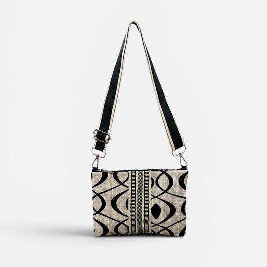 Patterned handbag with a strap on a white background