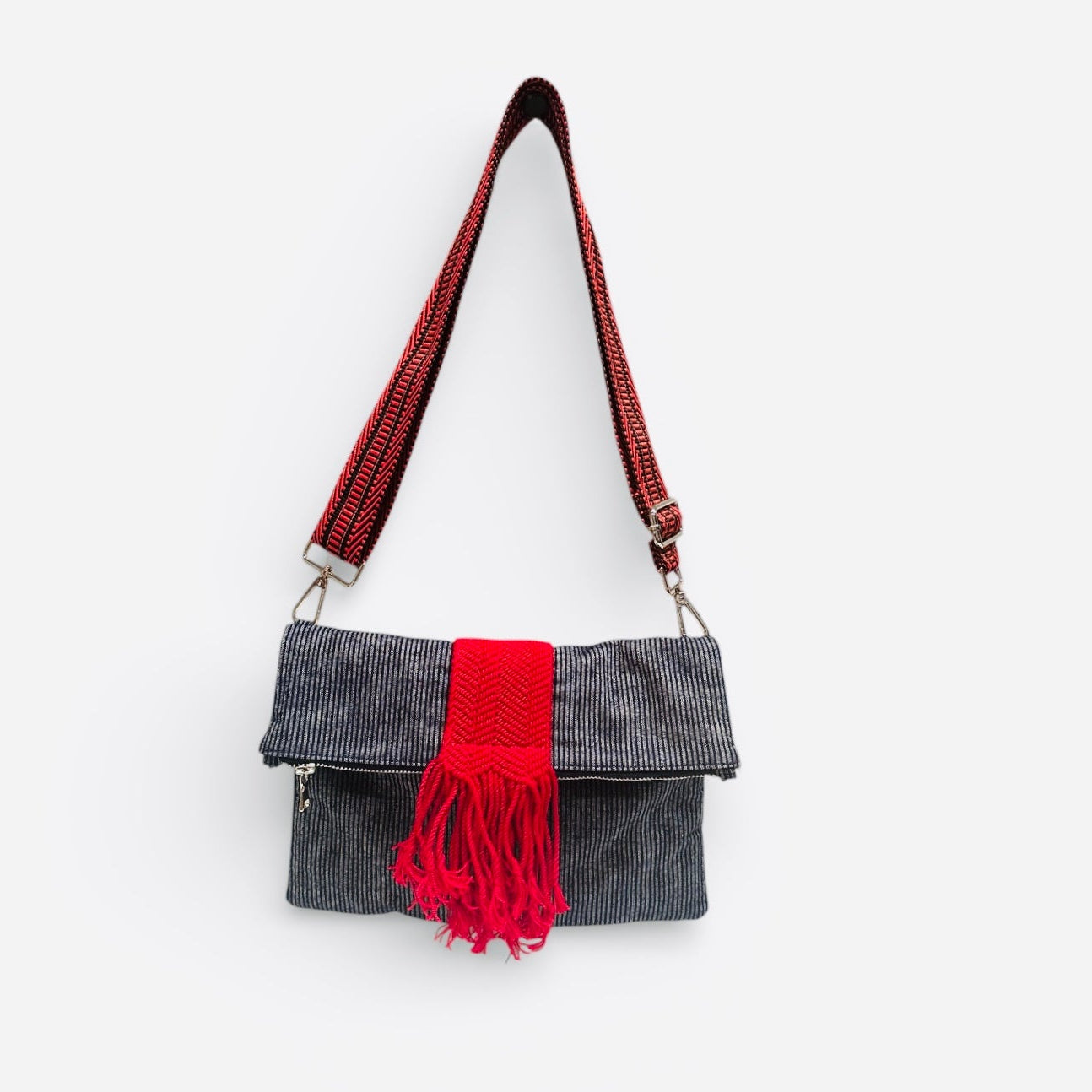 Minimalist navy denim pinstripe crossbody bag worn crossbody