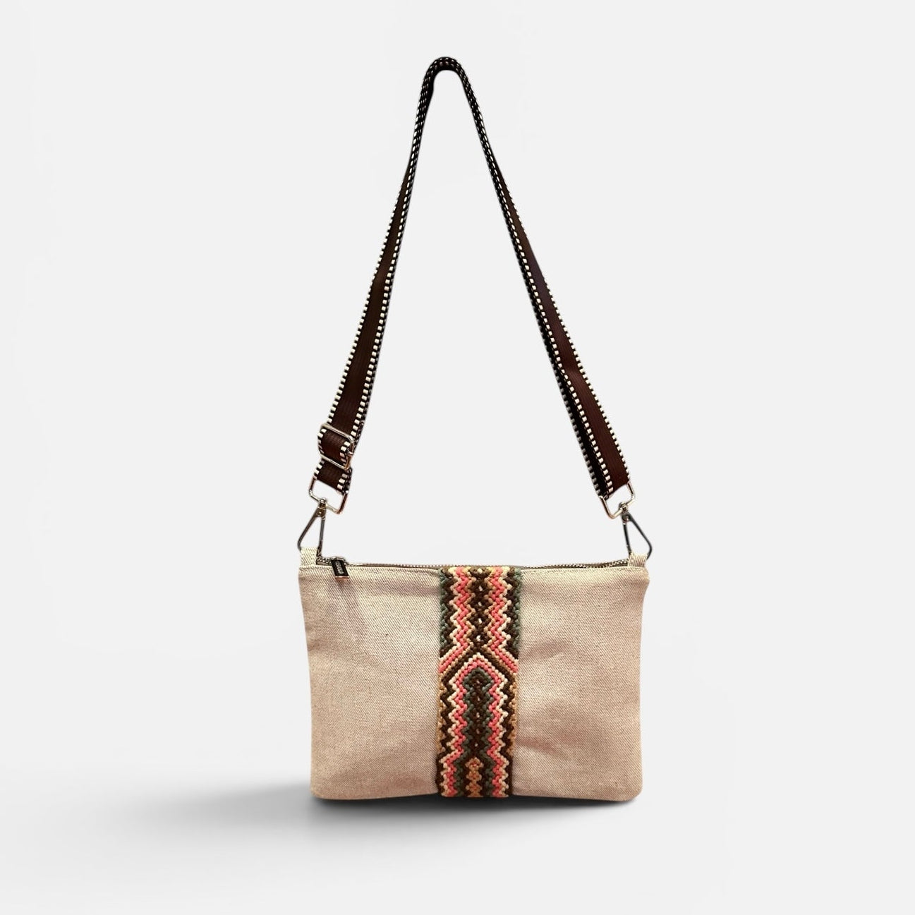 Beige handbag with a decorative strap on a white background