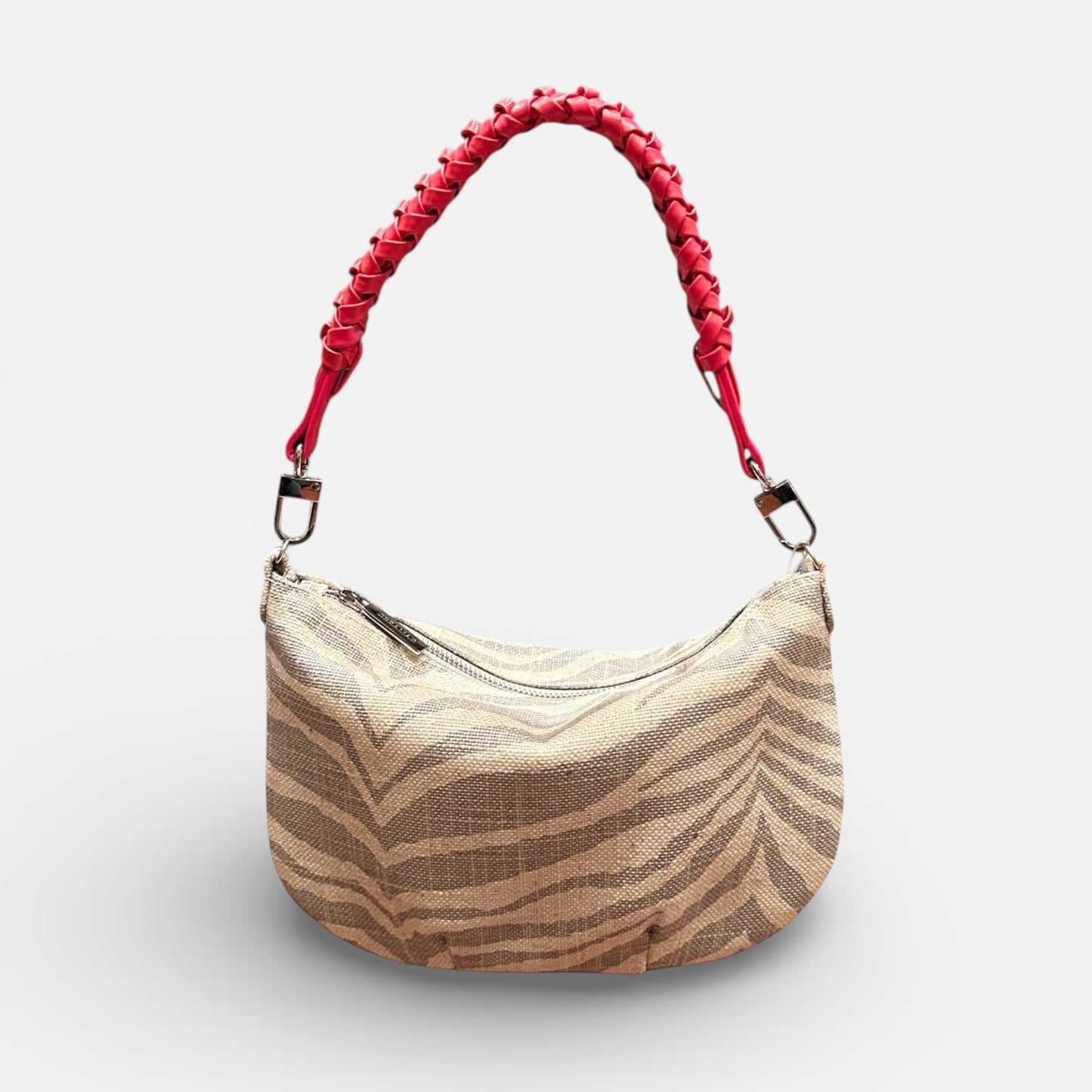 Beige handbag with red handle on a white background