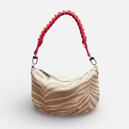 Beige handbag with red handle on a white background