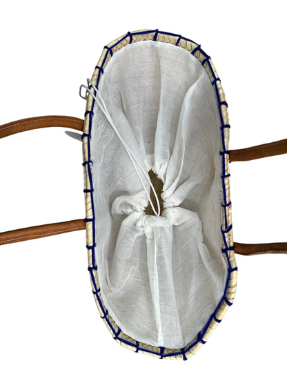 White mesh bag with blue trim on a wooden surface