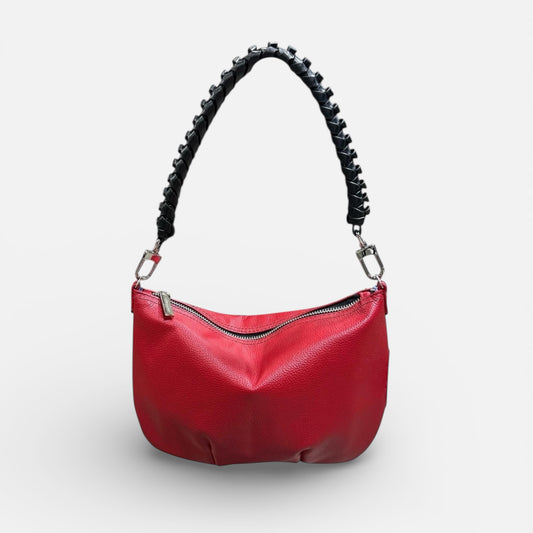 Red handbag with black braided handle on a white background