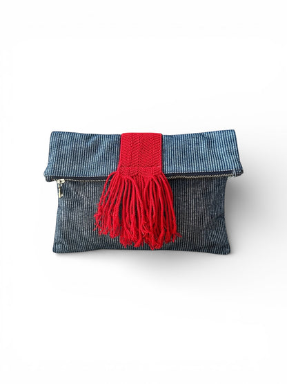 Navy denim pinstripe clutch bag with red accent details