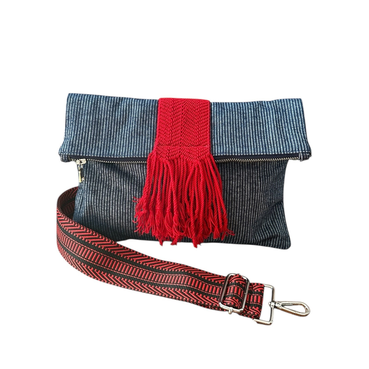 Navy denim pinstripe crossbody bag with red accent details