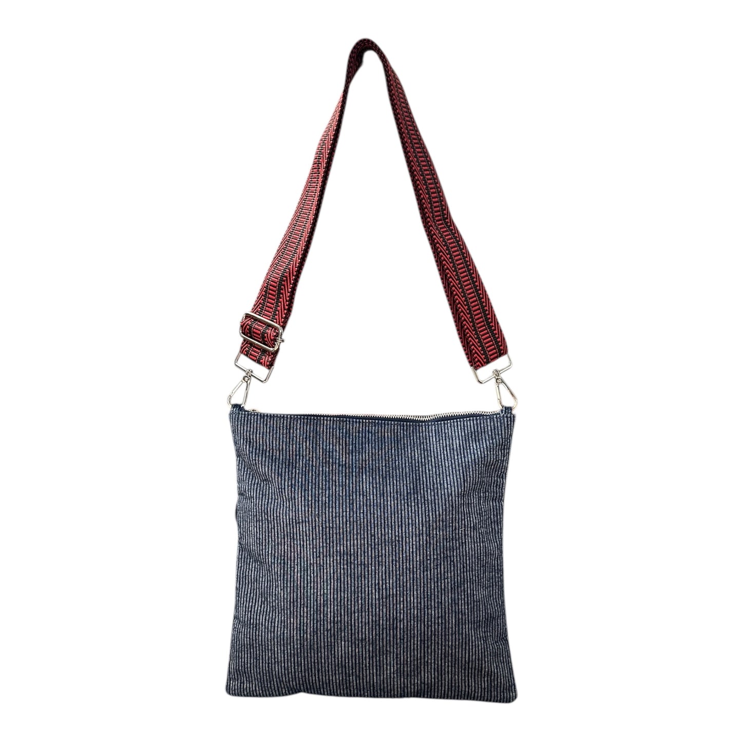Minimalist navy denim pinstripe crossbody bag worn crossbody