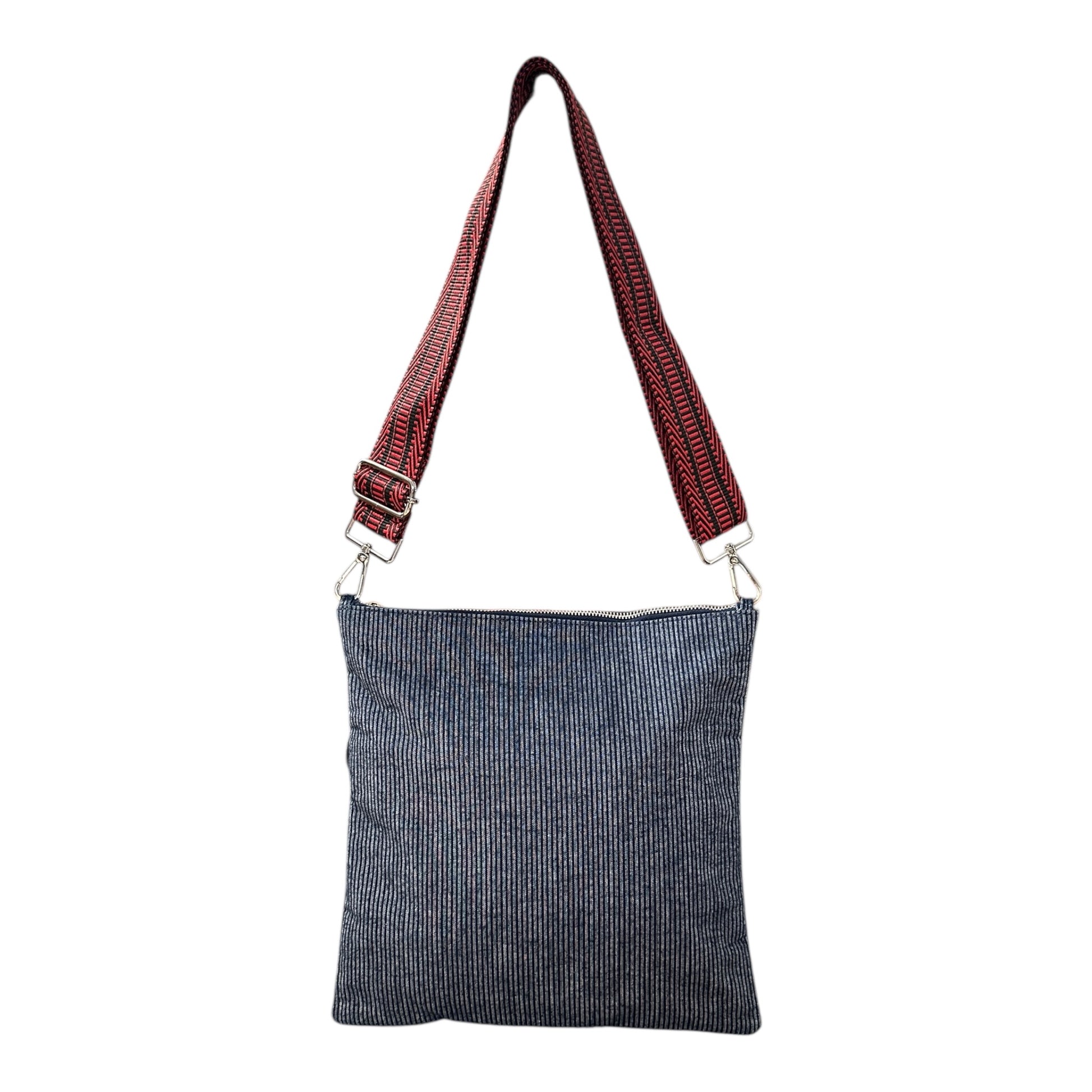 Minimalist navy denim pinstripe crossbody bag worn crossbody