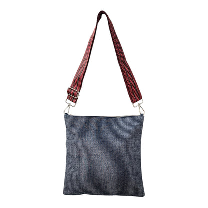 Minimalist navy denim pinstripe crossbody bag worn crossbody
