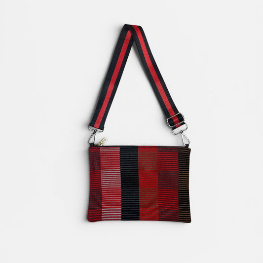 Red and black striped bag with a strap on a white background