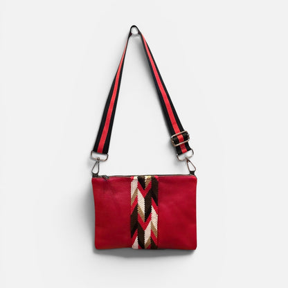 Red bag with a black and red strap on a white background