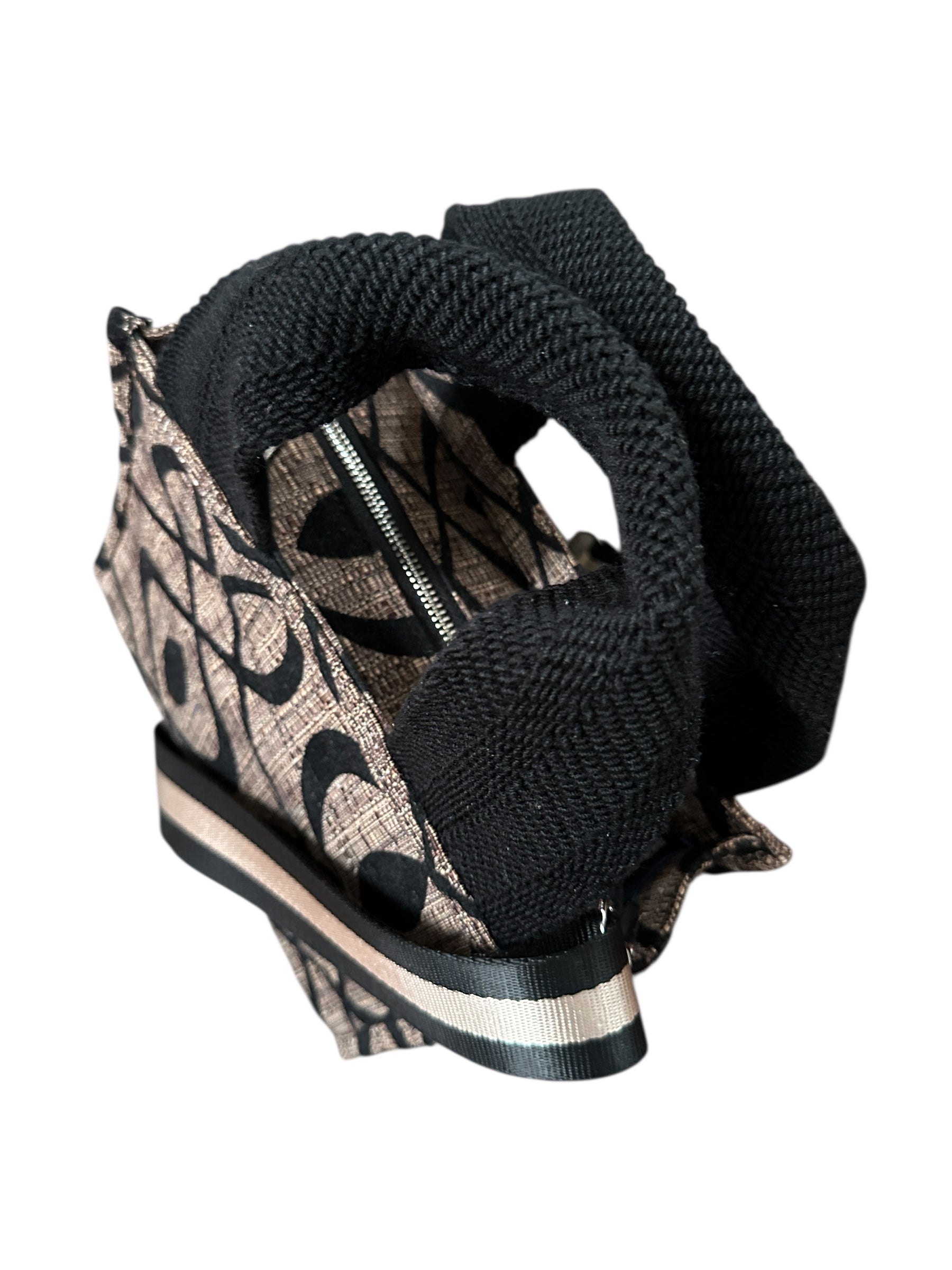 Patterned sandal with black knitted cover on a white background