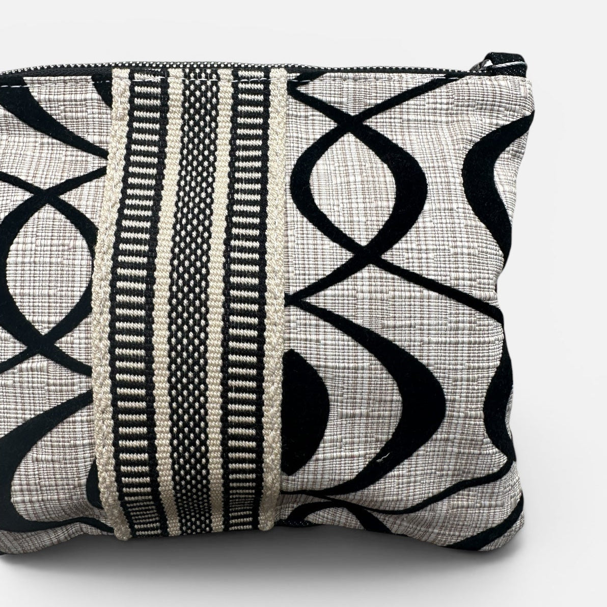 Black and cream patterned handbag on a white background