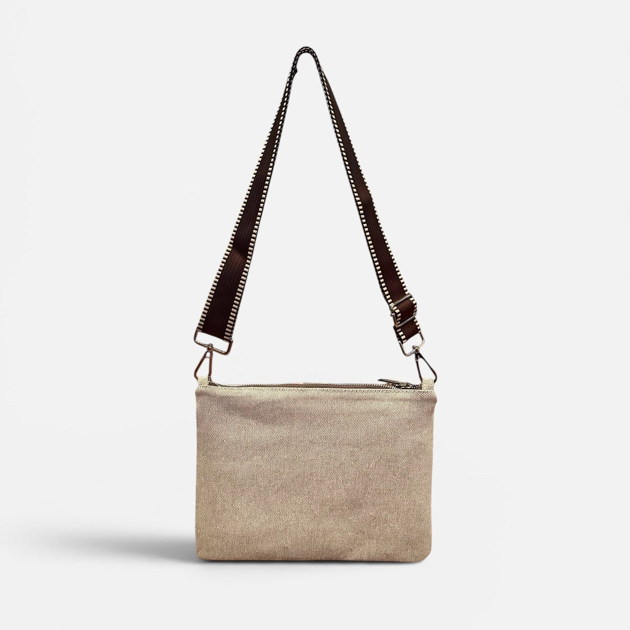 Beige crossbody bag with a strap on a white background