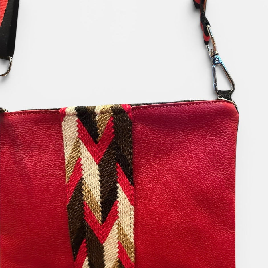 Red pouch with a patterned strap on a white background