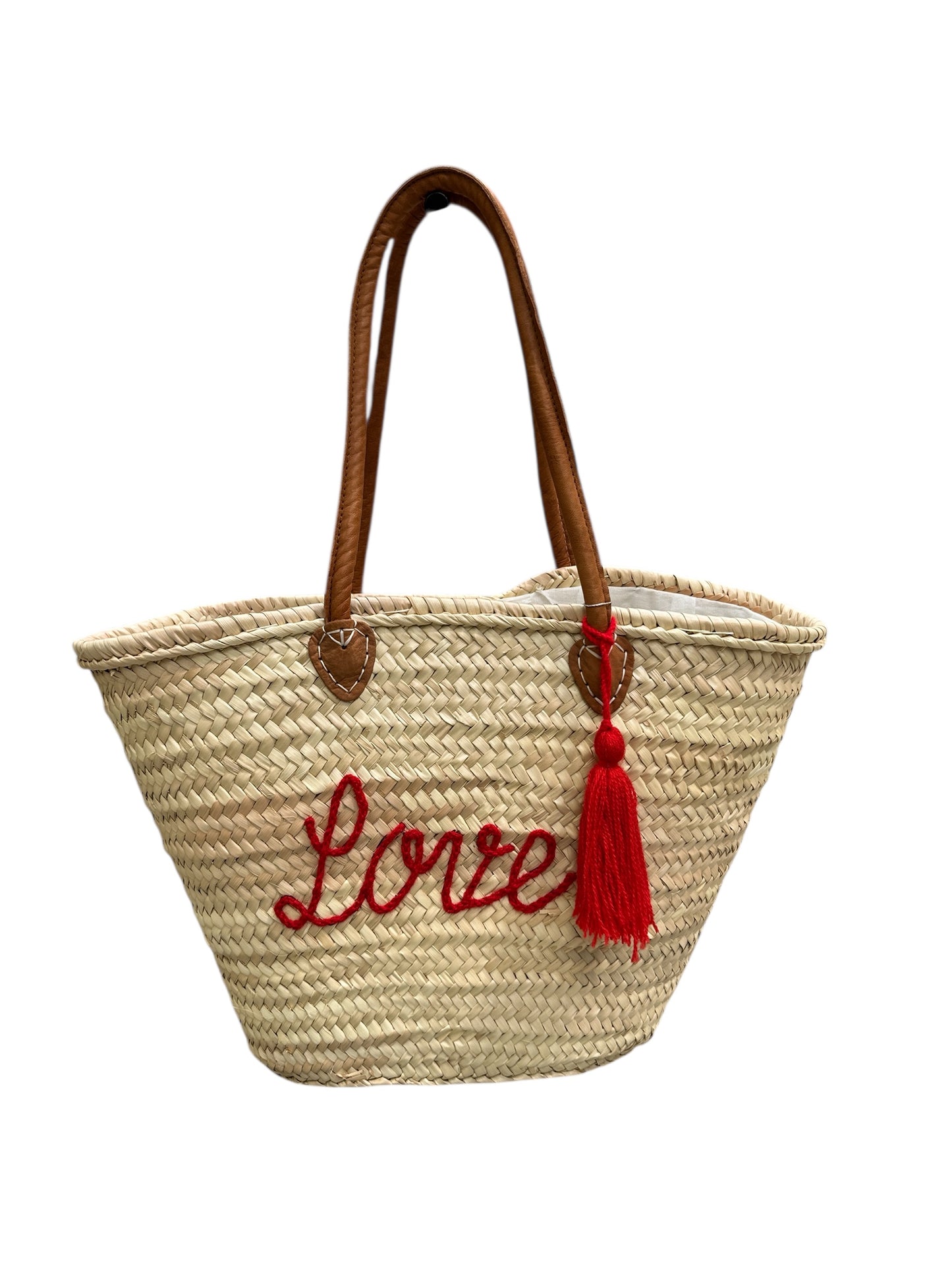 Woven bag with 'Love' embroidery and red tassel on a white background