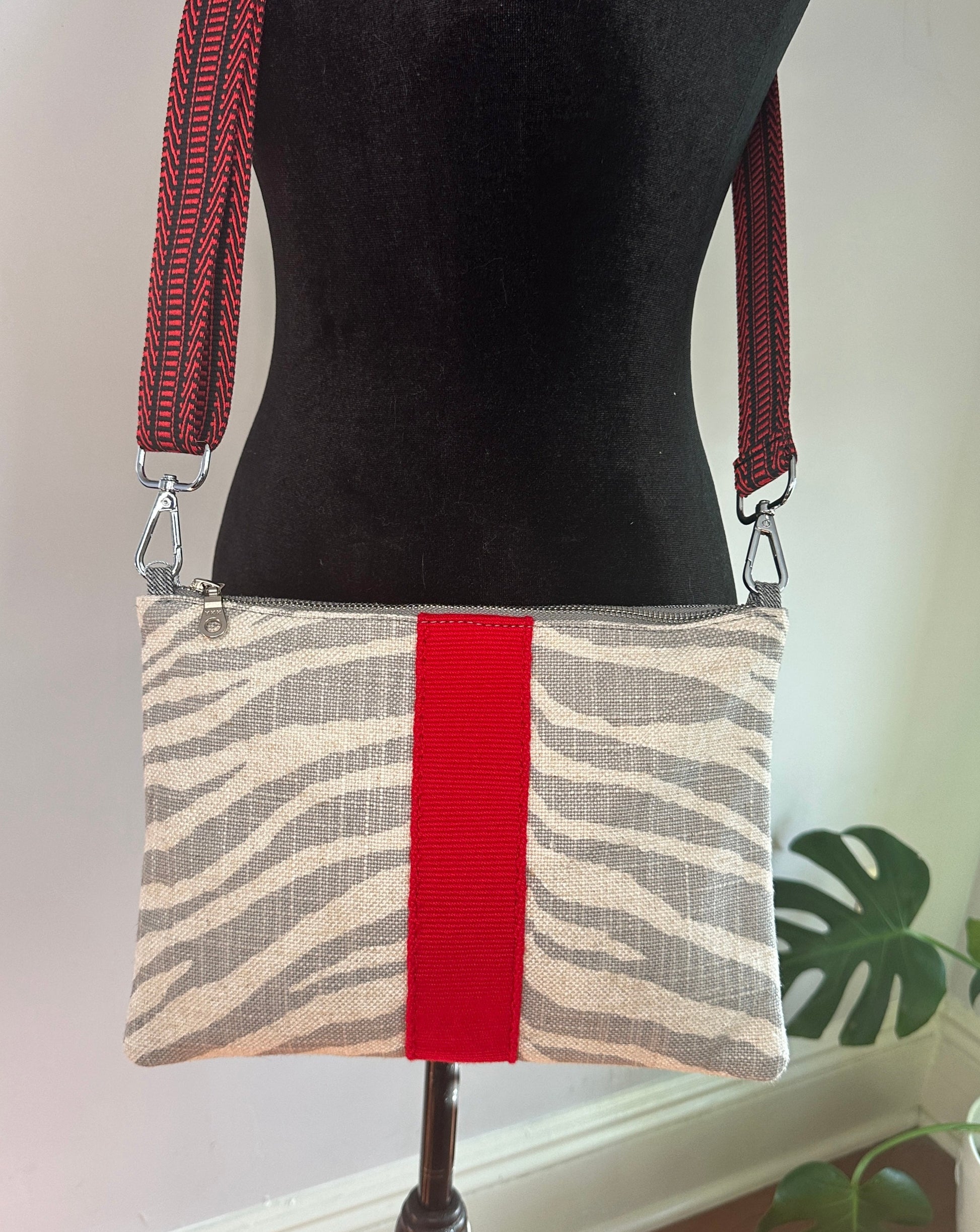 Grey and Cream zebra print with red and black guitar strap webbing.